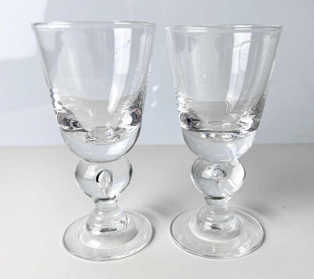 2pc Steuben Bubble Stem White Wine Glasses, marked Steuben: 2pc Steuben Bubble Stem White Wine Glasses, marked with "Steuben" on bottom. 2lb Approx. Measurements: 5 inches height x 2.625 in. diameter. Domestic Shipping: $20