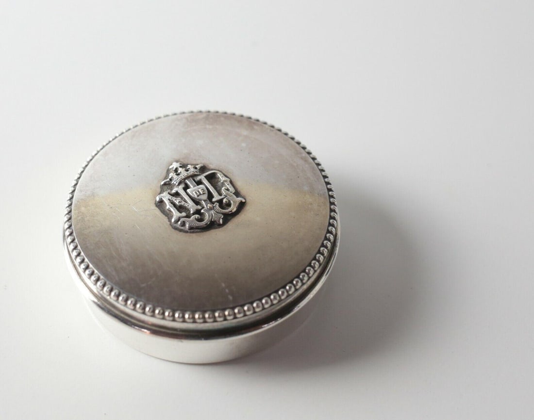Continental 900 Silver Snuff Pill Box beaded trim applied armorial: Continental 900 Silver Snuff Box, beaded trim, applied armorial with initials 'ND' with a smaller monogram in a shield 'DE' Measures Approx., 36.61grams (1.177ozt) 2.125 in diameter x 0.75 in height.