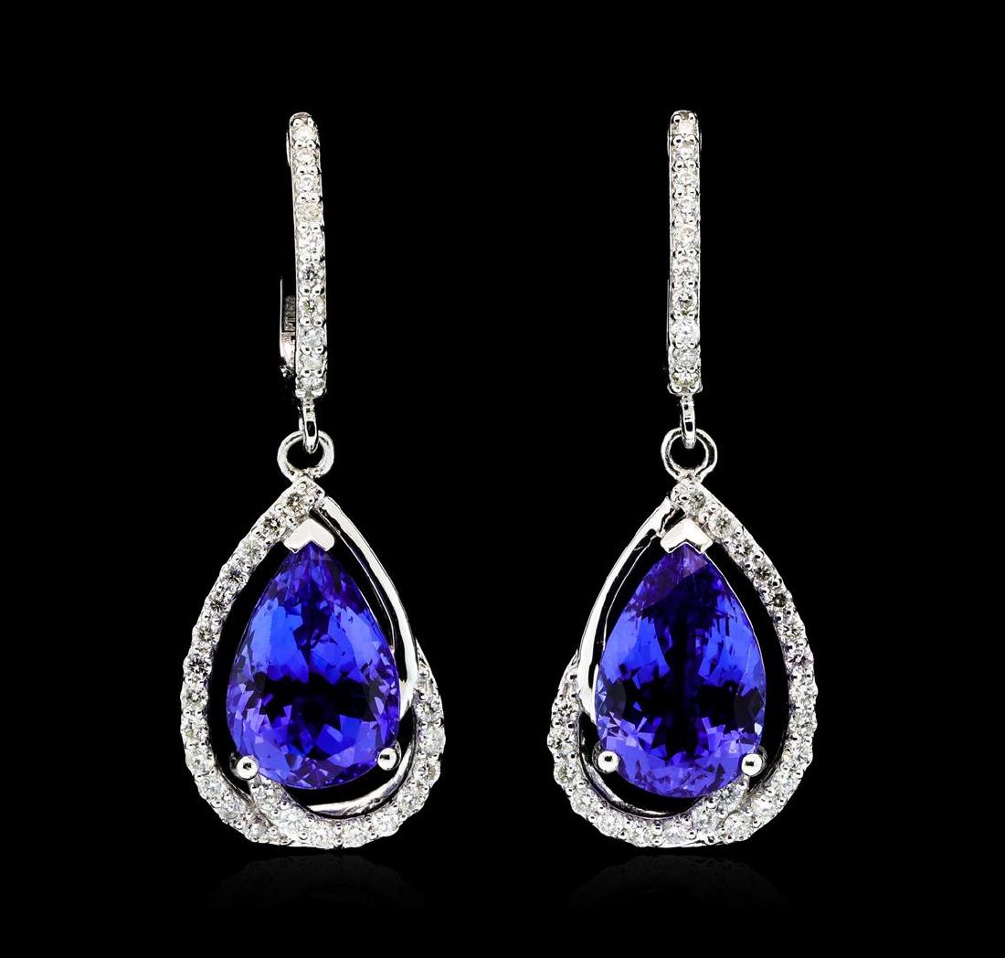 Platinum 8.17ctw Tanzanite and Diamond Earrings: One pair electronically tested platinum ladies cast & assembled tanzanite and diamond dangle earrings with hinged, snap locking posts. Each earring features a tanzanite set within a stylized diamond s
