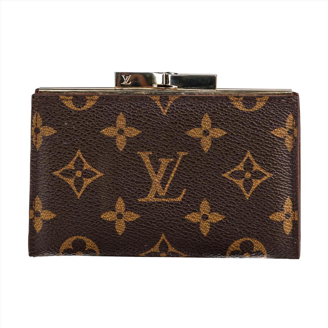 Louis Vuitton Monogram Coin Purse Card Wallet: Authentic Louis Vuitton Coin Purse Card Wallet in the brand's iconic brown monogram canvas. Golden hardware snaps closed in a beautiful bow design with the LV logo stamped on either side. The wallet o
