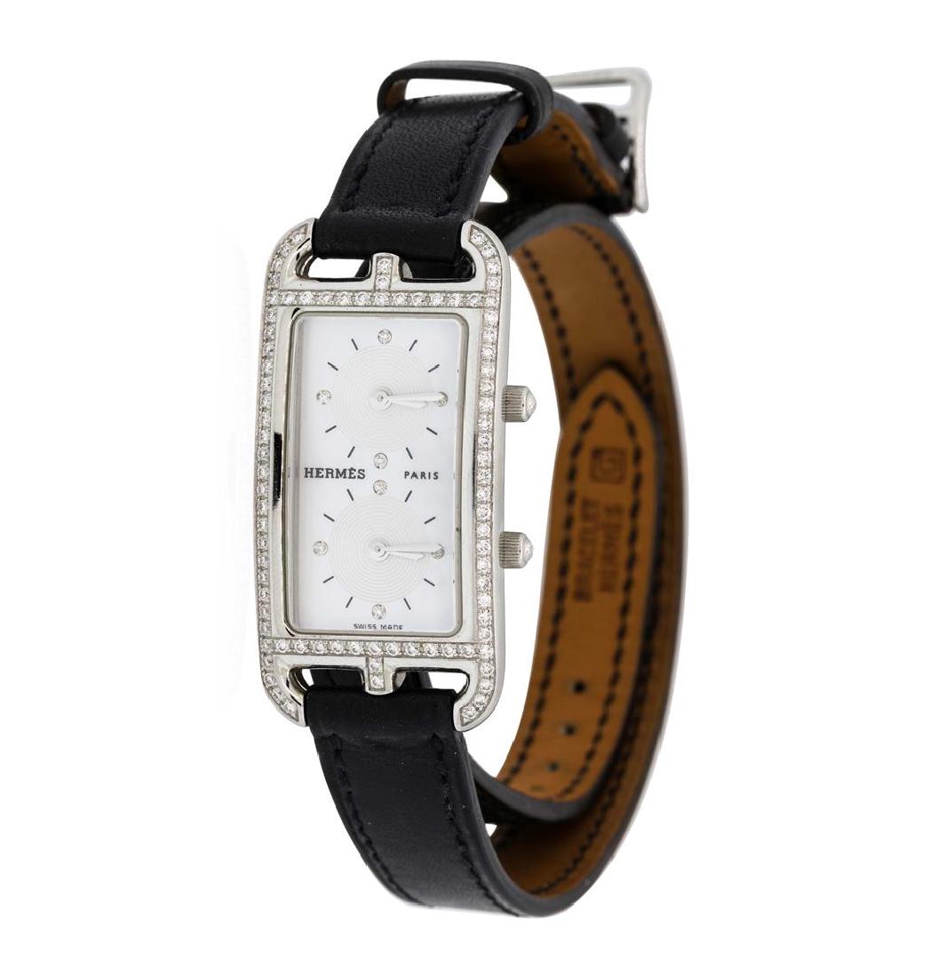 Hermes Ladies Stainless Steel and Diamond Cape Cod Dual: This watch contains the following specifications: Movement: Quartz, Dial: Dual Time Zone Double Dial, inlaid with two mother-of-pearl discs, with silver hands and markers, Bezel: Set with Round cut di