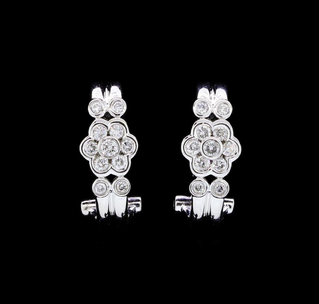 18KT White Gold 0.58ctw. Diamond Omega Back Earrings: One pair electronically tested 18KT white gold lady's combination cast & assembled fashion earrings with Omega clip backs with posts with a bright polish finish. Identified with markings of "18K 750".