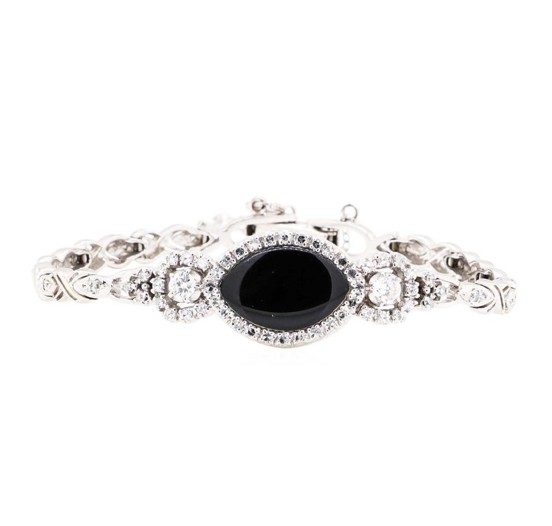 14KT White Gold 1.10ctw Diamond and Onyx Bracelet: One electronically tested 14KT white gold ladies combination cast & assembled fashion bracelet with a foldover clasp with safety chain with a bright polish finish. The featured ladies bracelet has a d