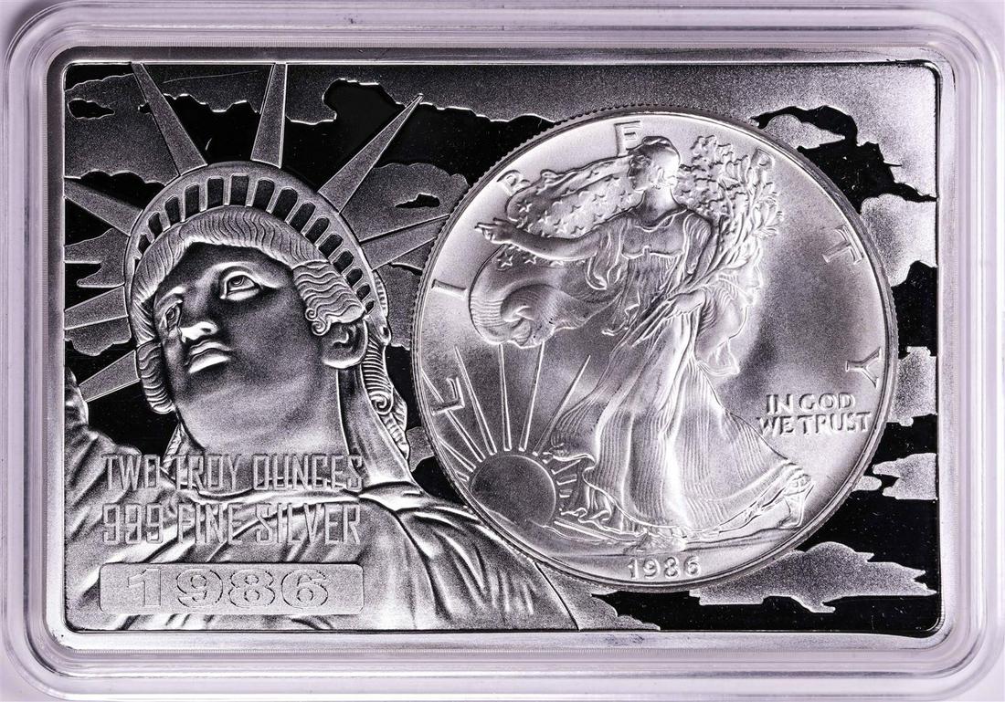 1986 $1 American Silver Eagle Coin & 2oz Silver Bar Set: One 1986 $1 American Silver Eagle Coin & 2oz Silver Bar Set.