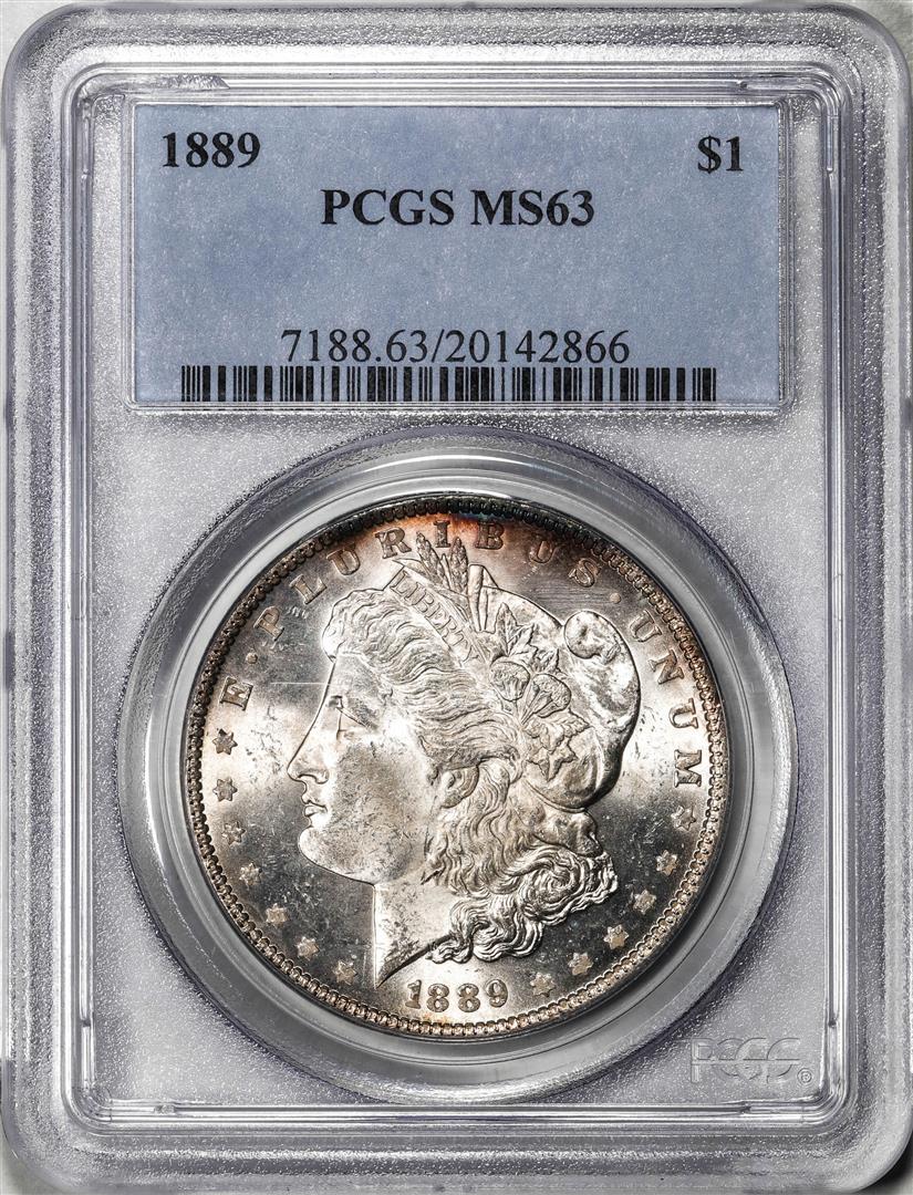 1889 $1 Morgan Silver Dollar Coin PCGS MS63: 1889 $1 Morgan Silver Dollar Coin PCGS MS63, please note that there is a small chip within the top left of the slab as shown. PCGS Graded.