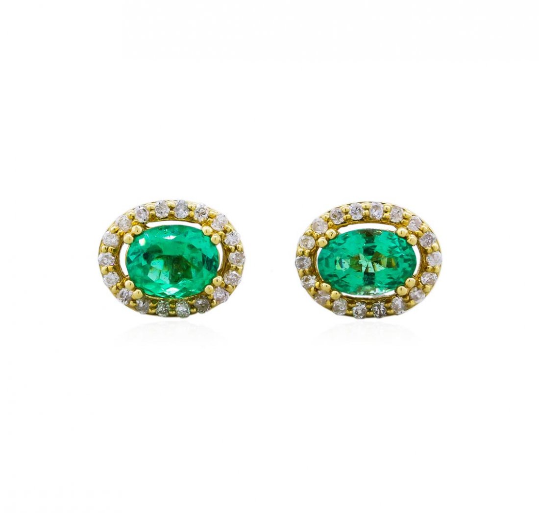 14KT Yellow Gold 1.12ctw Emerald and Diamond Earrings: 14KT yellow gold emerald and diamond earrings. 2 oval cut emerald beryl gemstones weighing in collectively at an aproximate 1.12 carats are prong mounted in the center of the earrings. Approximately 0