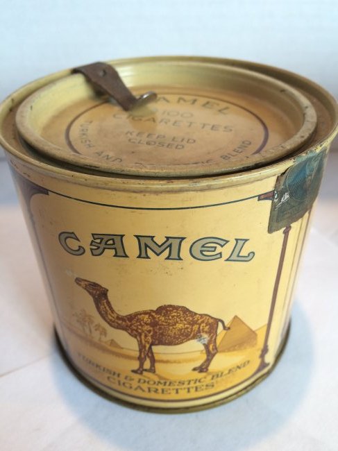 CAMEL 100's ROUND TIN EMPTY WITH LID AND OPENER 1975: 1975 CAMEL 100\'S EMPTY ROUND TIN WITH LID AND OPENER COUPLE SMALL DENTS $6 shipping to lower 48 states. COMBINED SHIPPING AVAILABLE
