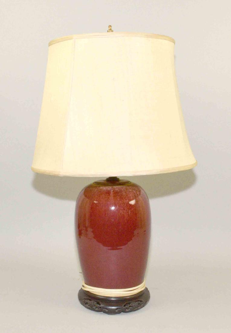 CHINESE SANG DE BOEUF PORCELAIN JAR, drilled and: CHINESE SANG DE BOEUF PORCELAIN JAR, drilled and mounted as a lamp. 13''H. Provenance: Mail Pouch Tobacco Estate.