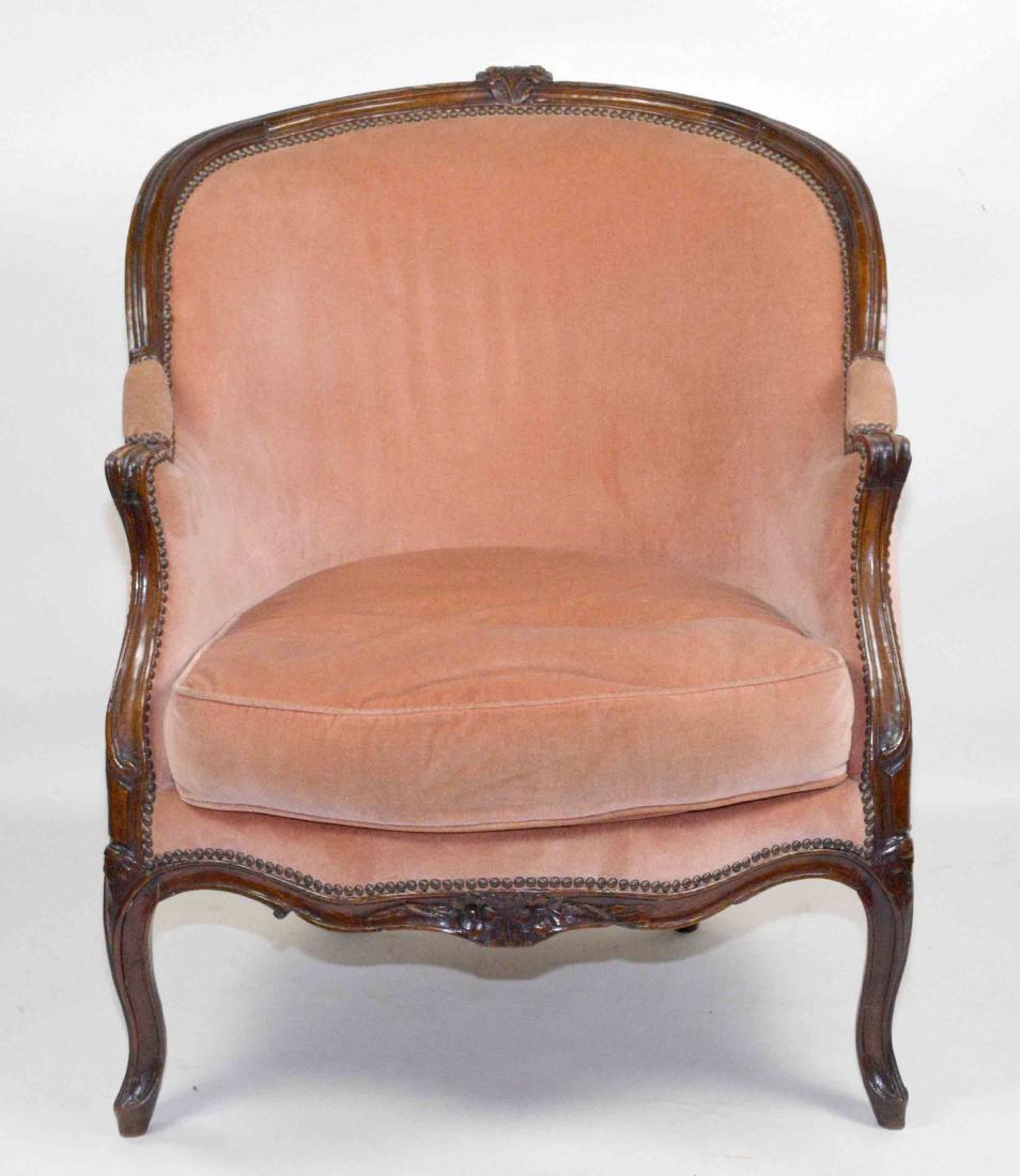 LOUIS XV STYLE FRUITWOOD BERGERE, 19TH C. covered in: LOUIS XV STYLE FRUITWOOD BERGERE, 19TH C. covered in coral velvet. 36.75''H x 30''W. Condition: worn. Provenance: Mail Pouch Tobacco Estate.