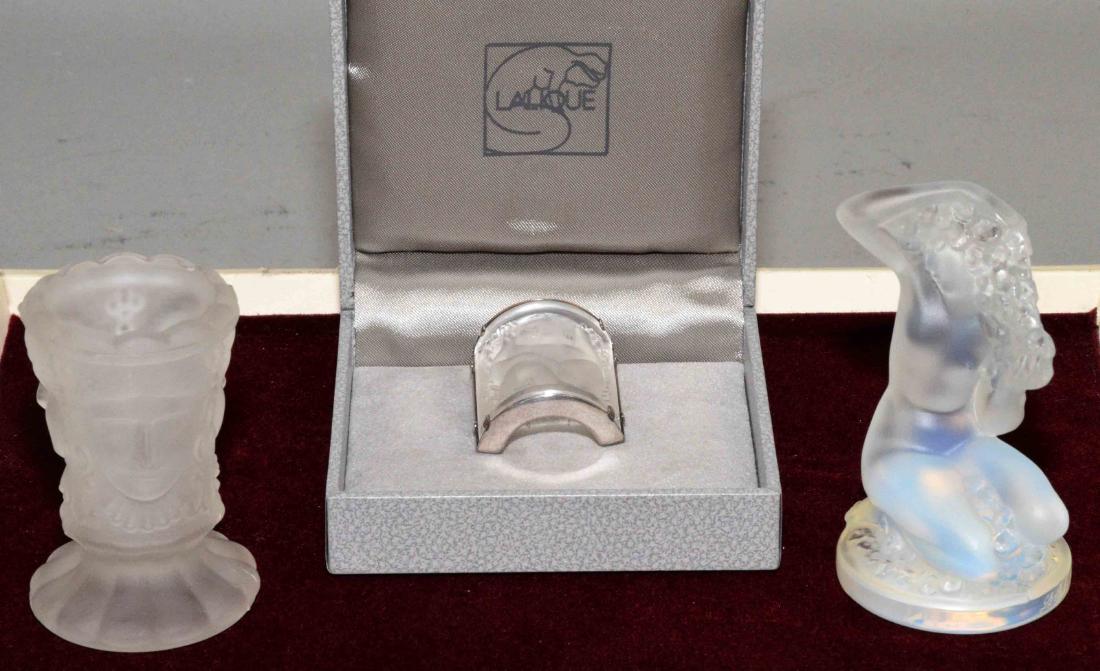 MISC. COLLECTION including a crystal Lalique brooch, a: MISC. COLLECTION including a crystal Lalique brooch, a frosted toothpick holder with three faces, and a Lalique statuette of a nude lady.