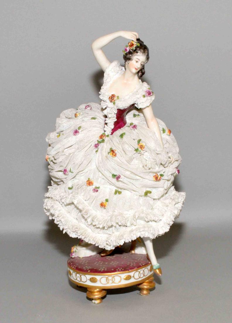 DRESDEN LACE BONE CHINA CRINOLINE PORCELAIN FIGURINE OF: DRESDEN LACE BONE CHINA CRINOLINE PORCELAIN FIGURINE OF A LADY DANCER. Blue crown mark. Condition: flower broken off hand, minimal damage to lace and flowers. 11''h x 6''w.