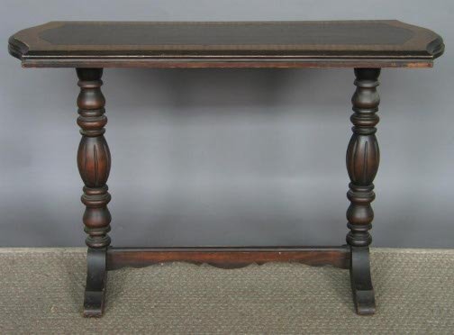 1940'S SOFA TABLE. Tudor style. Faux grained to: 1940'S SOFA TABLE. Tudor style. Faux grained top raised on turned lobed supports on shoe feet connected by a trestle. Size: 29'' H, 45'' W, 16'' D. Condition: numerous small scratches in the top.