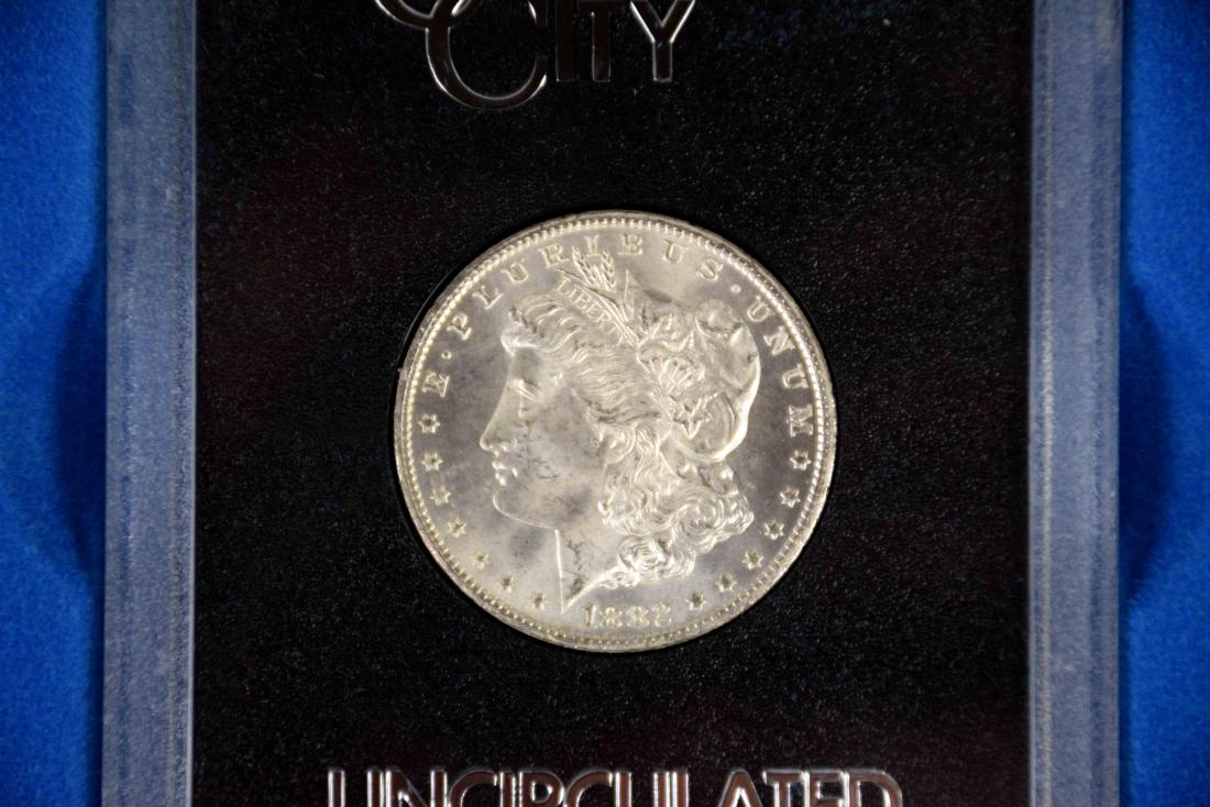1882-CC $1 morgan silver dollar coin uncirculated GSA (1 of 3)