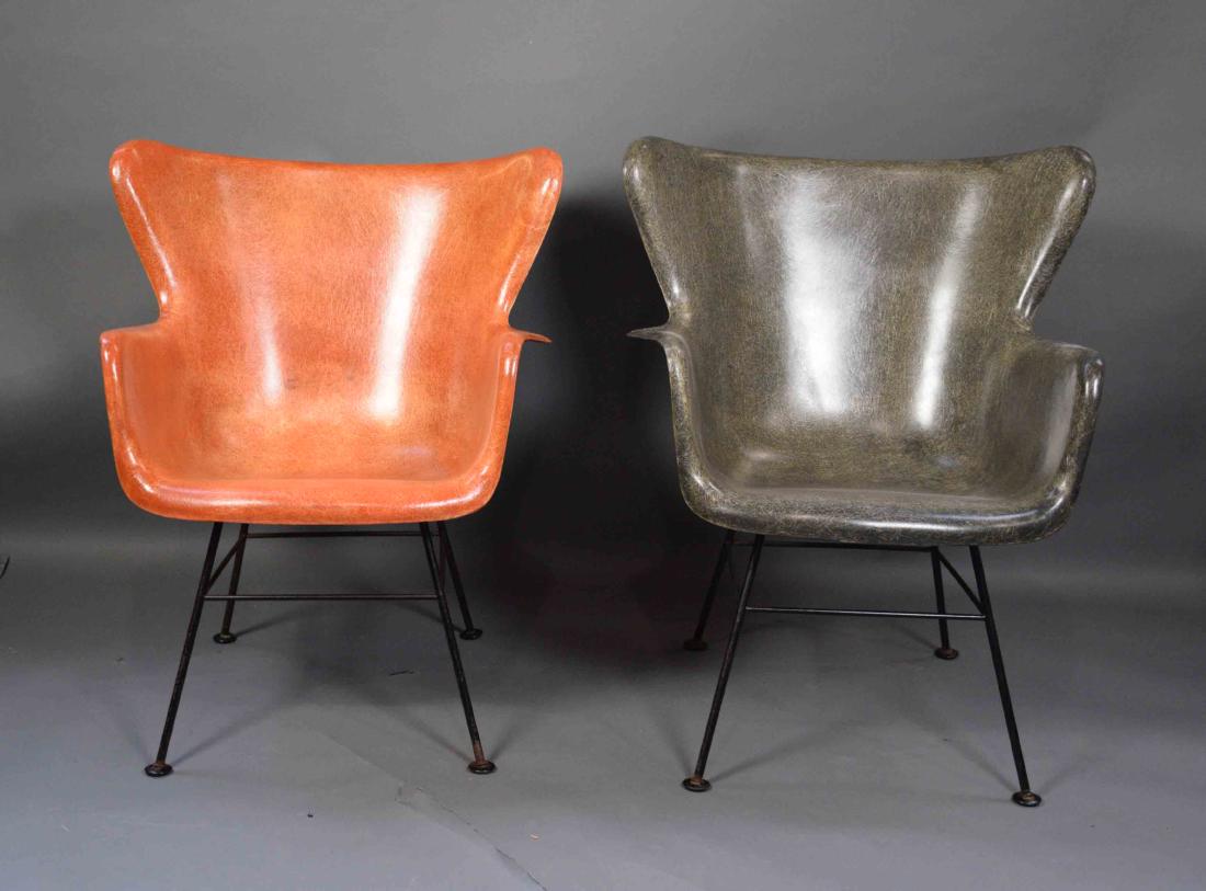 PAIR MID CENTURY FIBERGLASS CHAIRS. Designed by: PAIR MID CENTURY FIBERGLASS CHAIRS. Designed by Lawrence Peabody for Selig. Orange and grey with black metal frames. Age appropriate wear, some light surface rust in metal frames. 27''W x 27''D x 32.5