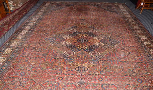 ANTIQUE PERSIAN RUG, in color rust. 20' x 12'.: ANTIQUE PERSIAN RUG, in color rust. 20' x 12'.