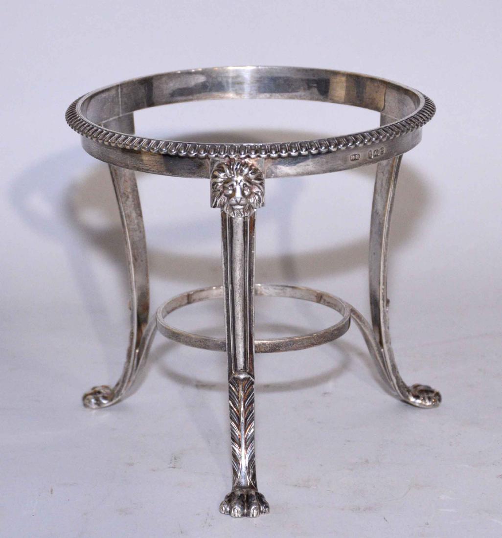 GEORGIAN STERLING STANDS. A Biggin stand, circular,: GEORGIAN STERLING STANDS. A Biggin stand, circular, with egg-and-dart rim with three leaf-capped paw feet, maker's mark KG, London, 1820, 5 1/2 in. high; 6 1/2 in. wide (each); weight 10 oz. troy (app