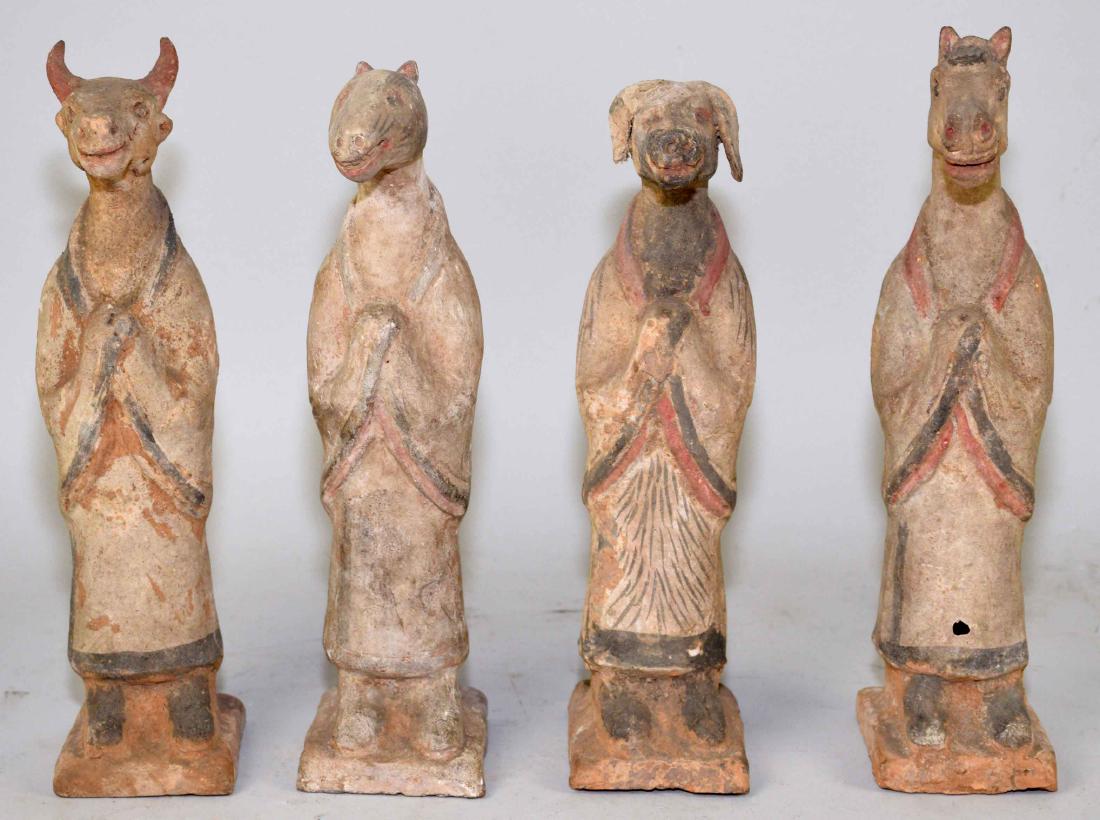 A SET OF FOUR CHINESE POTTERY TOMB FIGURES. Han Dynasty: A SET OF FOUR CHINESE POTTERY TOMB FIGURES. Han Dynasty (206 BC-220 AD). Modeled as a dog, a horse, a bull and a rat, all standing on their hind legs and wearing ceremonial robes, the underside of a f