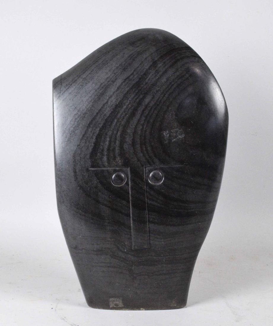 HENRY MUNYARADZI GREENSTONE SCULPTURE IN THE SHAPE OF A: HENRY MUNYARADZI GREENSTONE SCULPTURE IN THE SHAPE OF A HEAD. Signed 'Henry' (on bottom of base). 18 in. high, 12 in. wide; 4 1/2 in. deep. Condition: good.