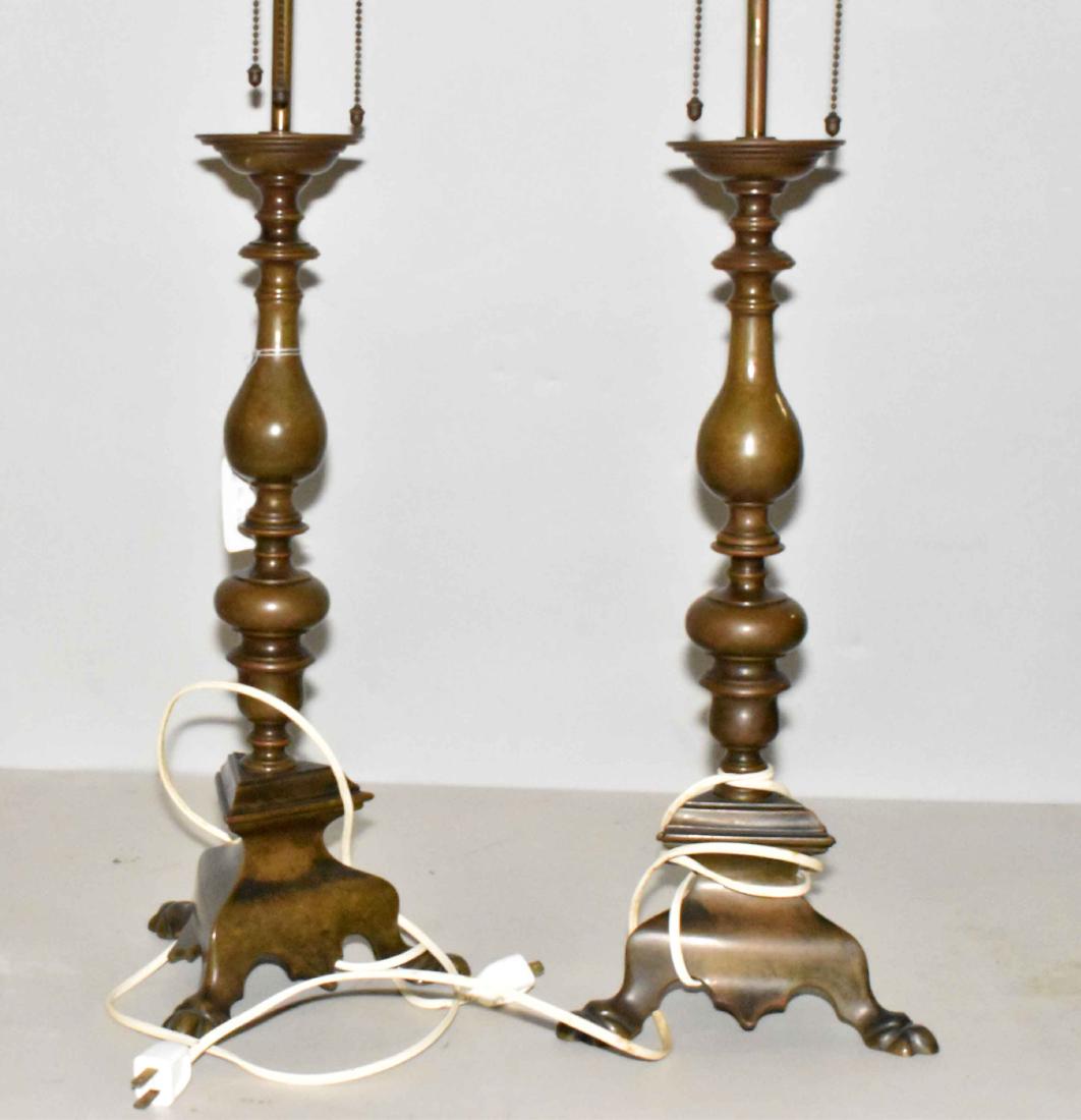 A PAIR OF CONTINENTAL BAROQUE BRONZE ALTAR: A PAIR OF CONTINENTAL BAROQUE BRONZE ALTAR CANDLESTICKS. 19th Century. Each with a knopped baluster stem and tripartite foot on foliate feet, drilled and mounted as lamps. 31 1/2 in. high (each; overa