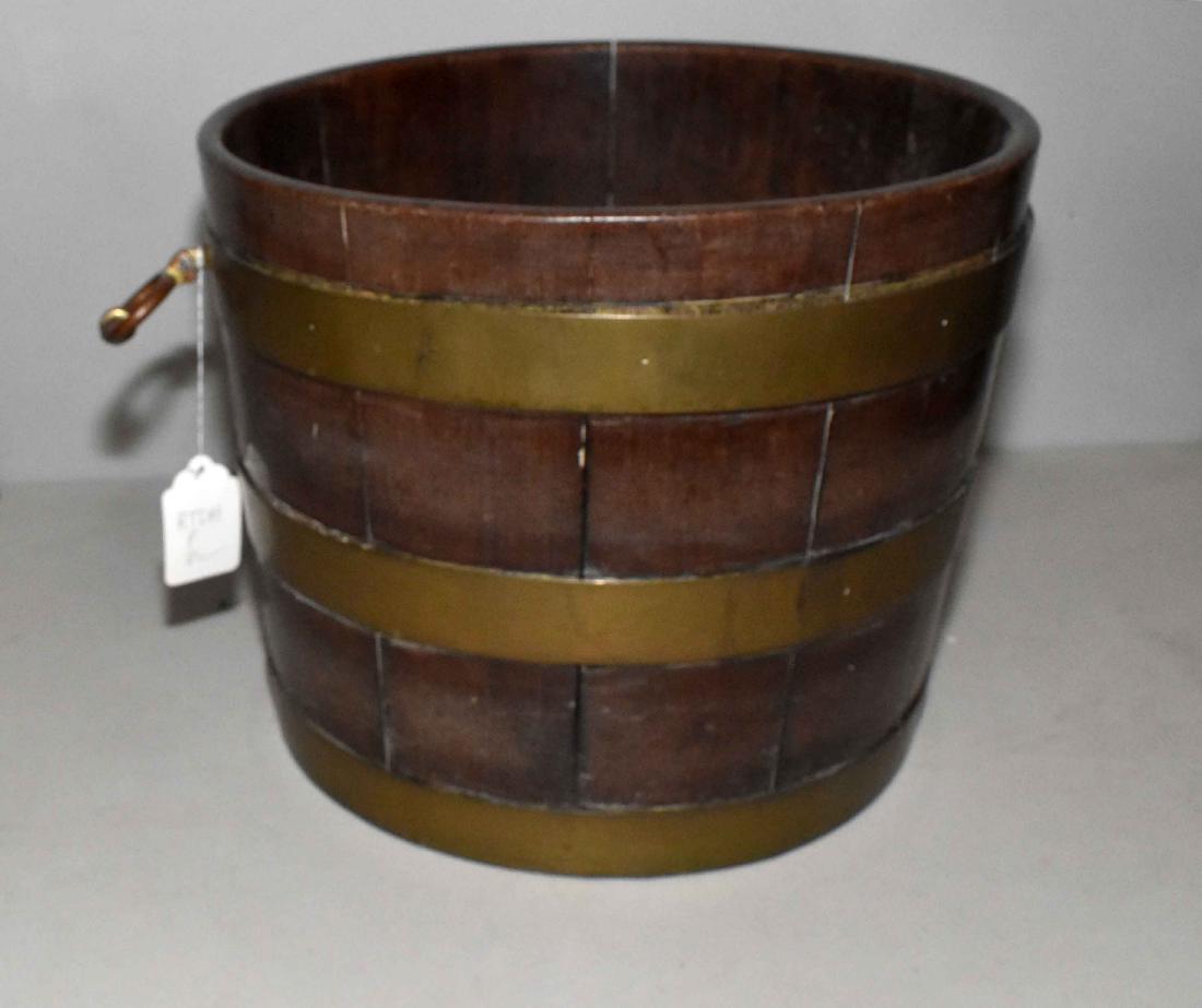 A GEORGE III BRASS-BOUND HOOP-AND-STAVE CONSTRUCTED: A GEORGE III BRASS-BOUND HOOP-AND-STAVE CONSTRUCTED SMALL CISTERN. 18th Century. Cylindrical, with three hoop bands and flanked by pendant ring handles, pierced at base for spigot, 13 in. high; 18 1/2