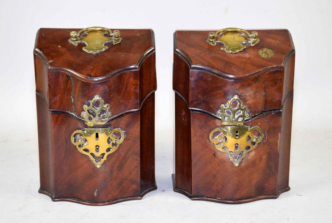 A PAIR OF GEORGE III BRASS-MOUNTED MAHOGANY SMALL KNIFE: A PAIR OF GEORGE III BRASS-MOUNTED MAHOGANY SMALL KNIFE BOXES. Late 18th Century. Each with a serpentine front and canted hinged lid, the bat's-wing pulls engraved with an armorial device, the interio