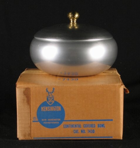KENSINGTON WARE CONTINENTAL BOWL. Art Deco alumin: KENSINGTON WARE CONTINENTAL BOWL. Art Deco aluminum and brass ''Continental covered Bowl'' cat. no. 7430. Designed by Lurelle Guild. Marked: stag head, shield and script mark. Size: 5''H, 7 1/4''Diam.