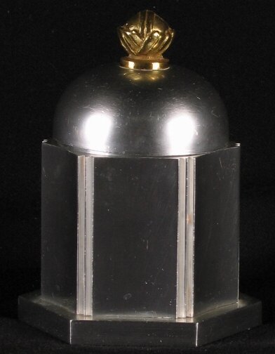 KENSINGTON WARE HEXAGON BOX. 1934-1935. Art Deco: KENSINGTON WARE HEXAGON BOX. 1934-1935. Art Deco aluminum and brass ''Hexagon Cigaratte box'' cat. no. 7541. Designed by Lurelle Guild. Patent applied for 11-11-1934. patent issued 1-8-1935. Early mar