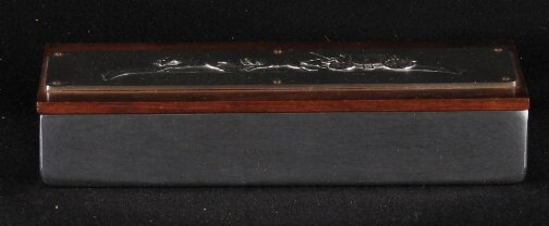 KENSINGTON WARE CIGARETTE BOX. Art Deco aluminum: KENSINGTON WARE CIGARETTE BOX. Art Deco aluminum and wood ''Coach 'N Four Cigarette Box'' cat. no. 7547. Designed by Lurelle Guild. Repousse decoration on lid. Marked: stag head, shield and script mar