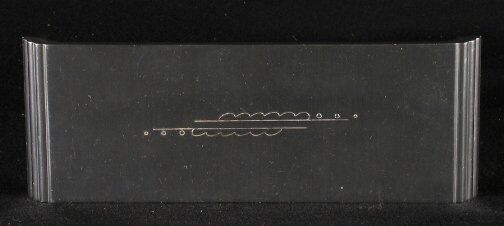 KENSINGTON WARE CIGARETTE BOX. Art Deco aluminum: KENSINGTON WARE CIGARETTE BOX. Art Deco aluminum and wood ''Buckingham Cigarette Box'' cat. no. 7546. Designed by Lurelle Guild. Wooden sides, incised metal top decoration. Marked: stag head, shield a