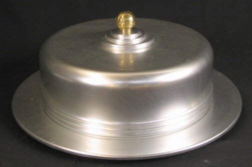 KENSINGTON YORKSHIRE CAKE TRAY. Art Deco aluminum: KENSINGTON YORKSHIRE CAKE TRAY. Art Deco aluminum and brass ''Yorkshire Covered Cake Tray'' cat. no. 7103. Designed by Lurelle Guild. Three pieces, aluminum base, aluminum lid with brass knob, round w