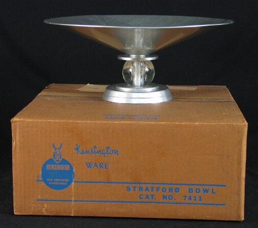 KENSINGTON WARE STRATFORD COMPOTE. c. 1934-35. De: KENSINGTON WARE STRATFORD COMPOTE. c. 1934-35. Designed by Lurelle Guild. Glass ball decoration. Cat. No. 7411. Marked: stag head, shield and script mark. Size: 13.5'' d. x 6'' h. Condition: in origin