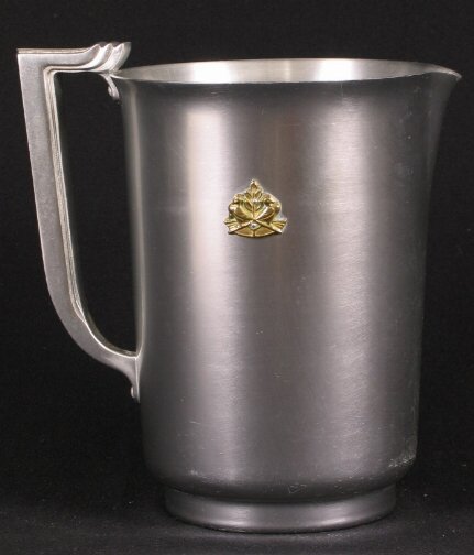 KENSINGTON WARE MAYFAIR PITCHER. 1934-35. Art Dec: KENSINGTON WARE MAYFAIR PITCHER. 1934-35. Art Deco aluminum and brass ''Mayfair Pitcher'' cat. no. 7231. Designed by Lurelle Guild, patent applied for 11-11-1934, patent issued 1-8-1935. Marked: stag