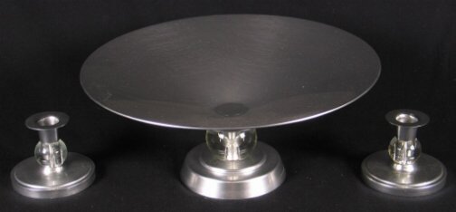 3 PC. KENSINGTON STRATFORD SET. 1934-1939. 3 Art: 3 PC. KENSINGTON STRATFORD SET. 1934-1939. 3 Art Deco aluminum and glass compote and candeholder set. ''Stratford Compote'' cat. no. 7411 designed by Lurelle Guild. Glass center knob. Two ''Stratford