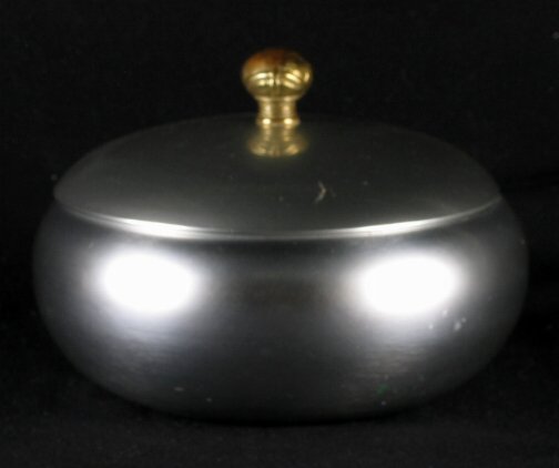 KENSINGTON WARE CONTINENTAL BOWL. Art Deco alumin: KENSINGTON WARE CONTINENTAL BOWL. Art Deco aluminum and brass ''Continental Covered Bowl'' cat. 7430. Designed by Lurelle Guild. Brass finial. Marked: stag head, shield and script mark. Size: 5''H, 7