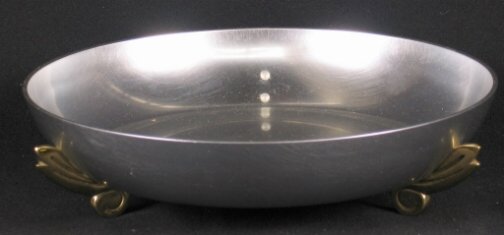 KENSINGTON WARE IMPERIAL FRUIT BOWL. C.1936. Art: KENSINGTON WARE IMPERIAL FRUIT BOWL. C.1936. Art Deco aluminum and brass ''Imperial Fruit Bowl'' cat. no. 7428. Designed by Lurelle Guild. Aluminum body with three brass feet. Later mark. Marked: stag