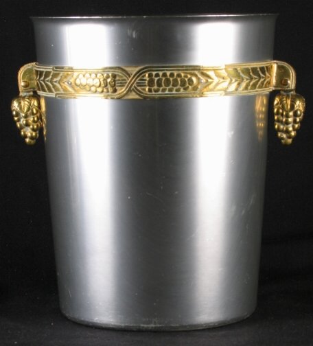 KENSINGTON WARE WINE COOLER. C. 1935. Art Deco al: KENSINGTON WARE WINE COOLER. C. 1935. Art Deco aluminum and brass ''Coldchester Wine cooler'' cat. no. 7250. Designed by Lurelle Guild. Aluminum body with brass frieze and brass grape pendant handles.
