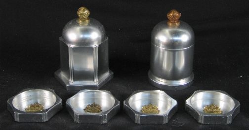 6 KENSINGTON CIGARETTE ITEMS. six Art Deco alumin: 6 KENSINGTON CIGARETTE ITEMS. six Art Deco aluminum and brass Cigarette items, designed by Lurelle Guild. Includes: (3) Hexagonal ashtrays with brass decoration cat. no. 7610. Two with early marks, on