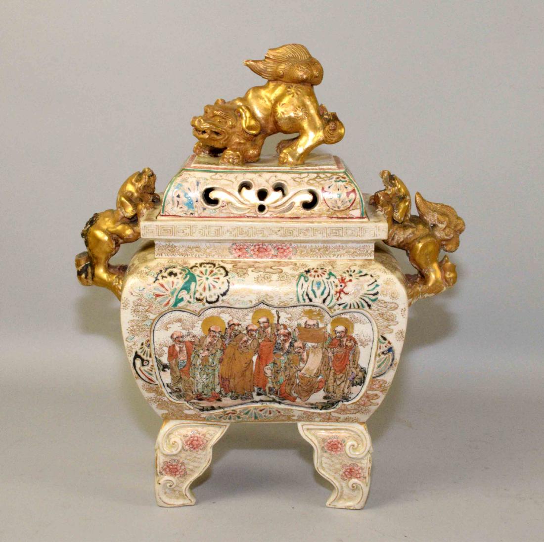 ANTIQUE SATSUMA MEIJI INCENSE BURNER. Turn of the: ANTIQUE SATSUMA MEIJI INCENSE BURNER. Turn of the century footed early Satsuma incense burner w/lid on carved teakwood stand. Stand depicting carved dragons, claw feet and face. Burner depicting Asian