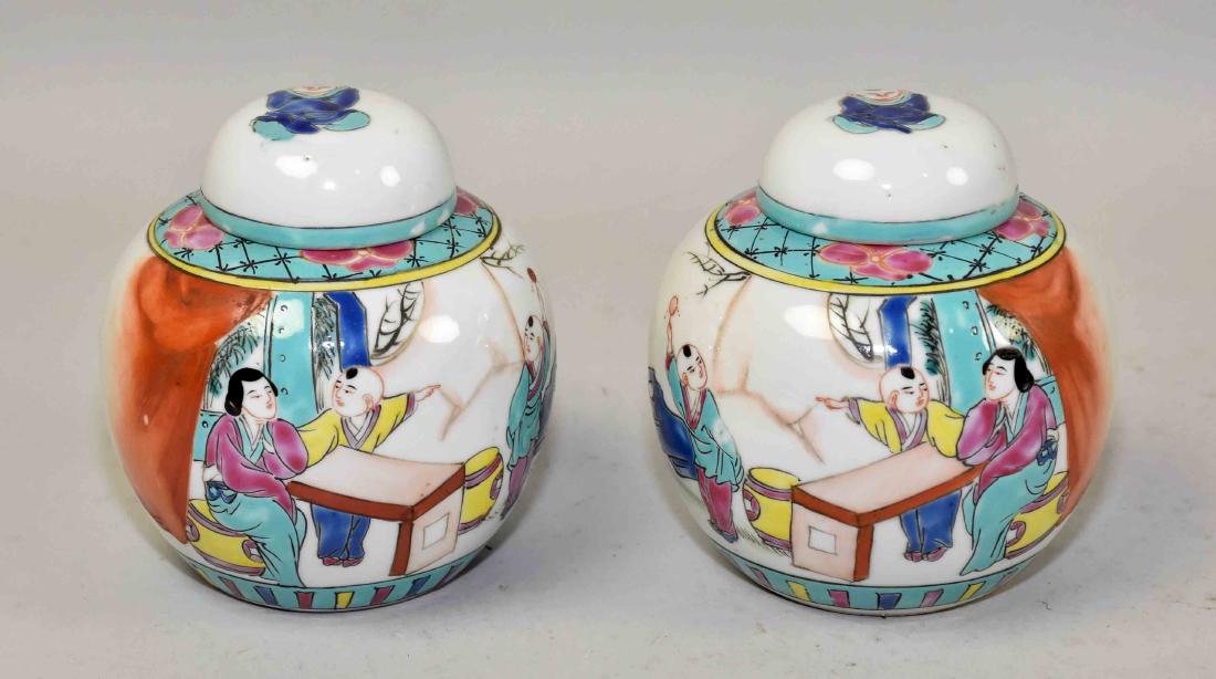 VINTAGE COVERED CHINESE FAMILE ROSE PORCELAIN PAIR OF: VINTAGE COVERED CHINESE FAMILE ROSE PORCELAIN PAIR OF GINGER JARS: Pre 1920 era. Hand painted figures and insects. Marked China in red on bottom. Excellent condition. 4.50''H x 3.50'' diameter.