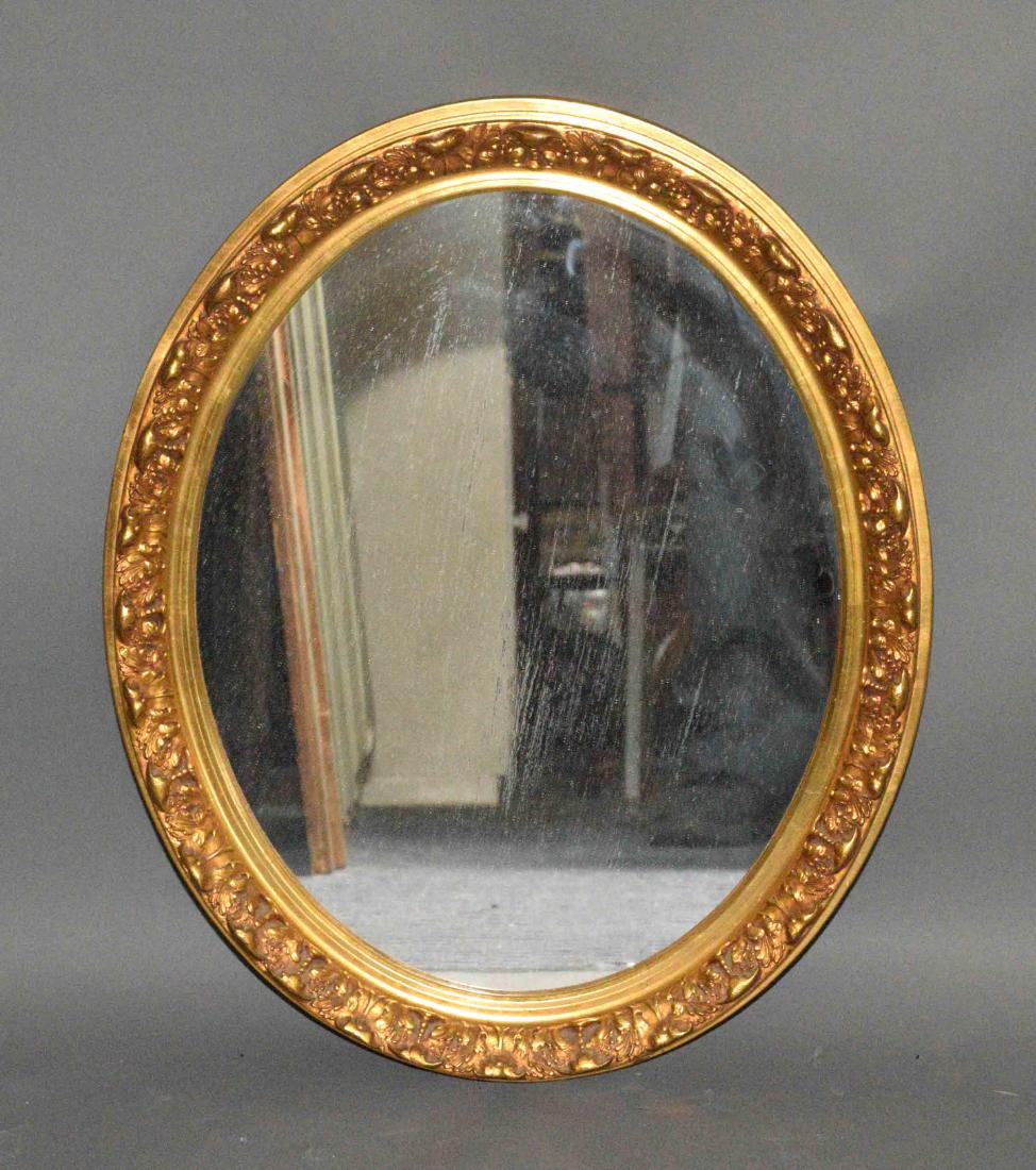GOLD GILT OVAL MIRROR. 24''H x 19.5''W.: GOLD GILT OVAL MIRROR. 24''H x 19.5''W.