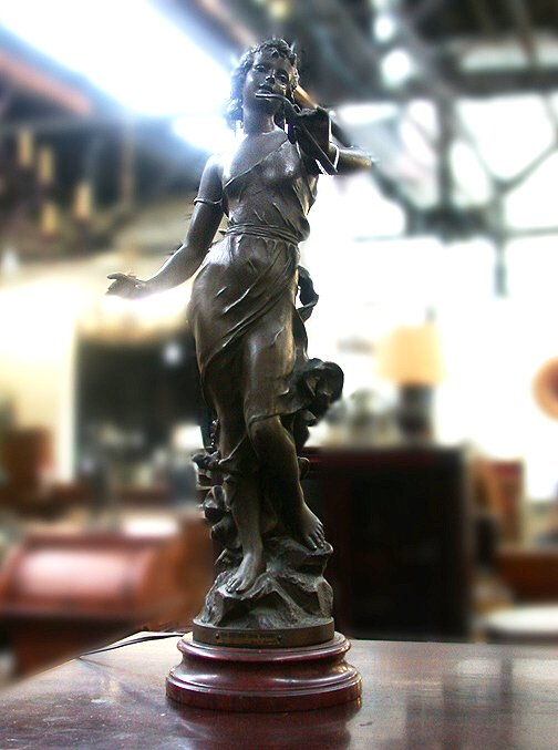 FIGURAL METAL LAMP. N/R. Metal. Cast me: FIGURAL METAL LAMP. N/R. Metal. Cast metal figural lamp on stone base. The figure is labeled "La Muse des Bois" by J. Causse. Size: figure 24"H, lamp with harp 36"H. Condition: object in hand is bent.
