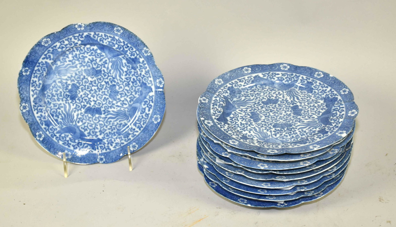 (10) ORIENTAL BLUE AND WHITE PORCELAIN PLATES.: (10) ORIENTAL BLUE AND WHITE PORCELAIN PLATES. W/Phoenix bird design and scalloped rim. Fair condition with chips to each plate, one repaired. 8.50'' diameter. Estate of Stephen Totter.