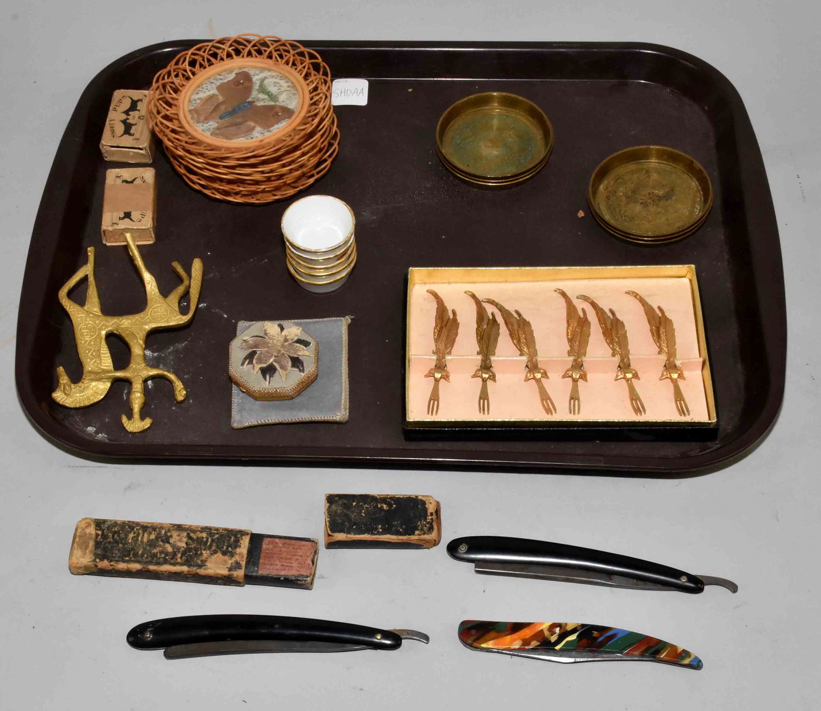 (10+) PC. ASST. LOT OF COLLECTIBLES. Including shaving: (10+) PC. ASST. LOT OF COLLECTIBLES. Including shaving razors, coasters, 24K plated cocktail forks, compact, snooty pups and a brass horse. Largest: 6''L.