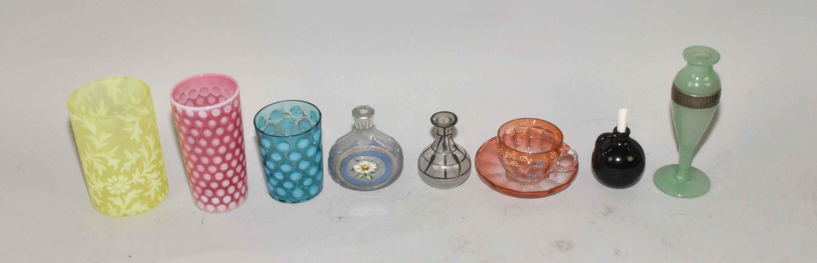 COLLECTION OF COLORED GLASS CUPS AND VASES. Condition:: COLLECTION OF COLORED GLASS CUPS AND VASES. Condition: good, no chips. 6.50''T.