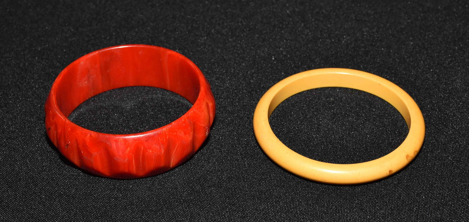 (2) LADIES BAKELITE BRACELETS, in red and yellow.: (2) LADIES BAKELITE BRACELETS, in red and yellow.
