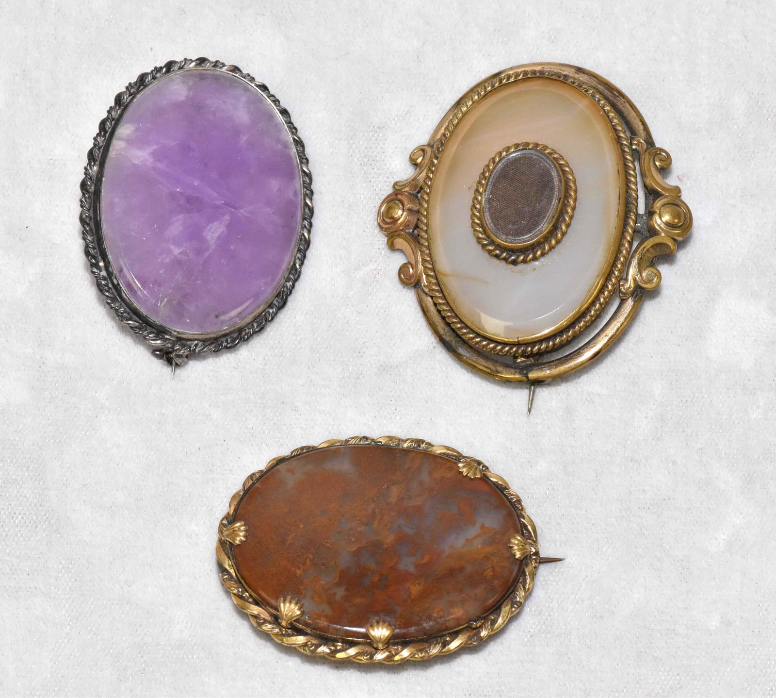 (3) ANTIQUE VICTORIAN BROOCHES. Moss agate, amethyst: (3) ANTIQUE VICTORIAN BROOCHES. Moss agate, amethyst and agate. Largest: 2''W x 1.75''H