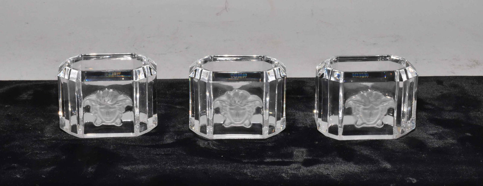 (3) VERSACE ROSENTHAL MEDUSA CRYSTAL NAPKIN RINGS. Mint: (3) VERSACE ROSENTHAL MEDUSA CRYSTAL NAPKIN RINGS. Mint condition. 1.75''H x 2.25''W. Estate of Stephen Totter.