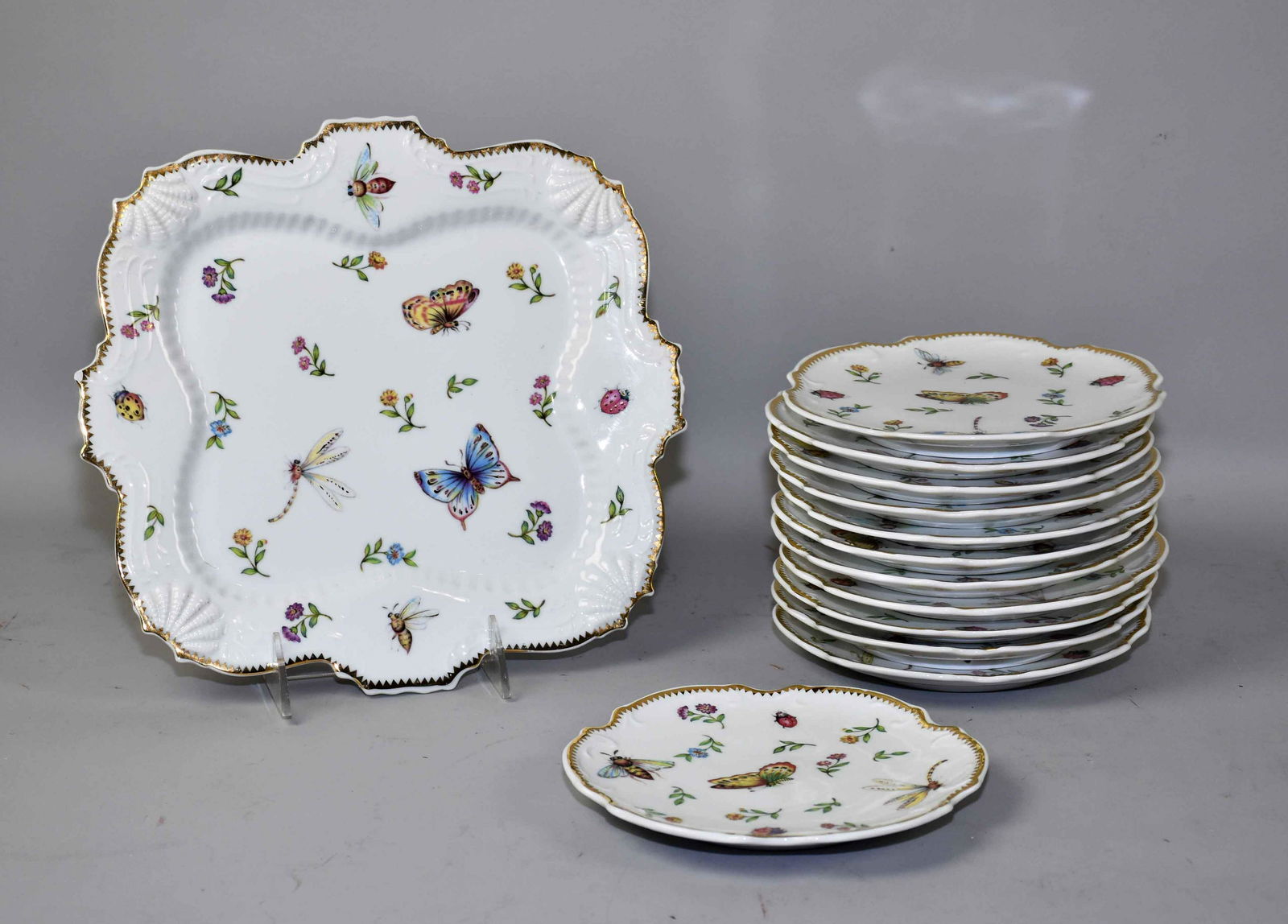 (13 PC.) I. GODINGER & CO. ASST. CHINA: 10'' square: (13 PC.) I. GODINGER & CO. ASST. CHINA: 10'' square platter w/(12) dessert plates in ''Primavera''. Black stamp w/Bug - sm. plates 6.25'' diameter. Estate of Stephen Totter.
