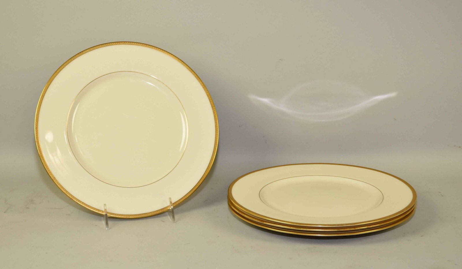 (4) VINTAGE TIFFANY & CO/LENOX CHINA DINNER PLATES, in: (4) VINTAGE TIFFANY & CO/LENOX CHINA DINNER PLATES, in ivory w/gold gilt band. 10.25'' diameter. W/green stamp. 1830/S.62. Estate of Stephen Totter.