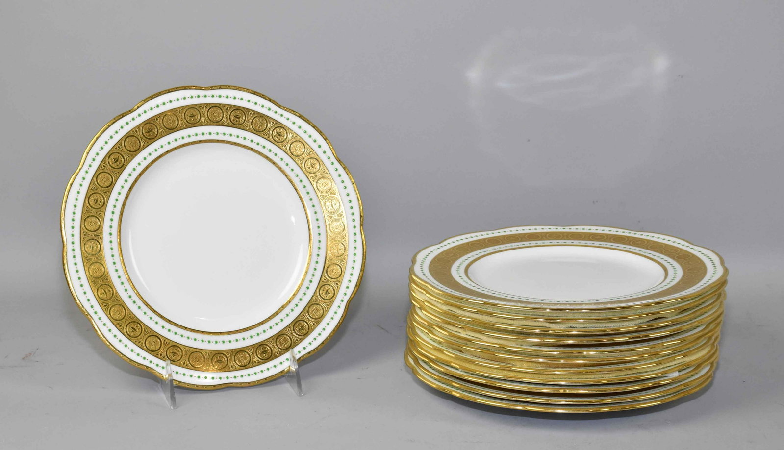 SET OF (12) MINTON CHINA SALAD PLATES - H2309. White: SET OF (12) MINTON CHINA SALAD PLATES - H2309. White w/gilt band and green emerald dots. Red stamp, 9''d. Estate of Stephen Totter.